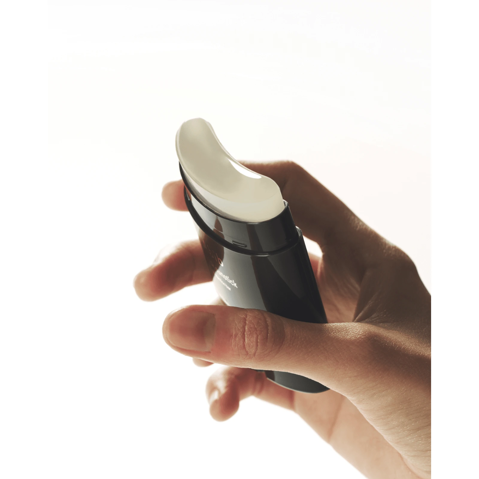 Abib Quick Sunstick held in hand ready to apply over the face