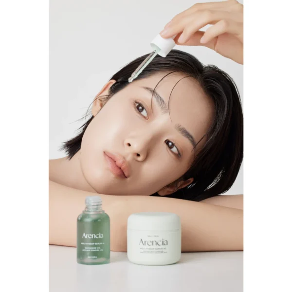 Applying Arencia Holy Hyssop Serum 12 with the dropper after essence
