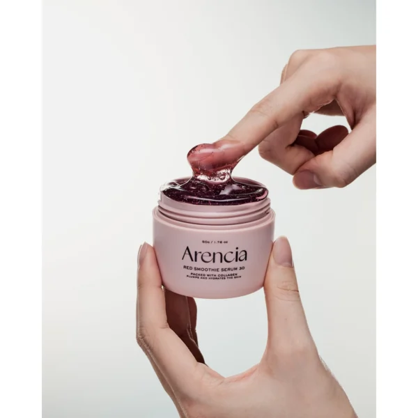 Scooping Arencia Red Smoothie Serum 30 from the jar with a fingertip