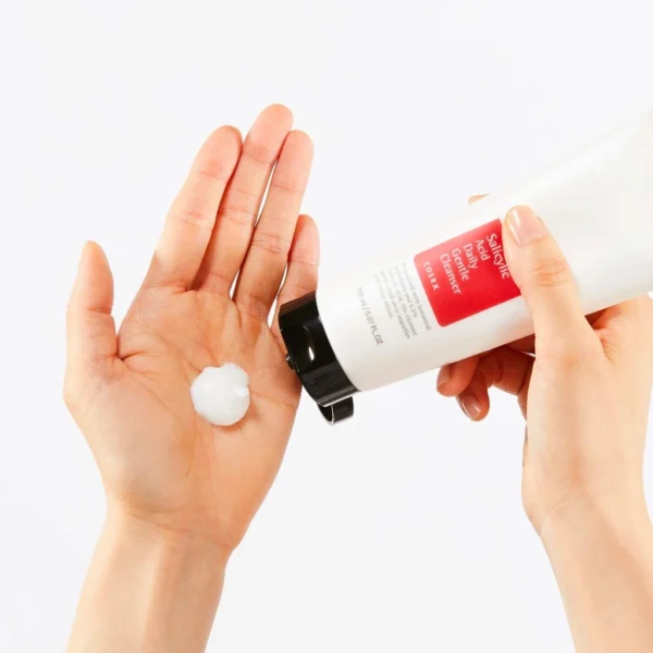 COSRX Salicylic Acid Cleanser being dispensed into the palm, showing the dense foam the soap base produces