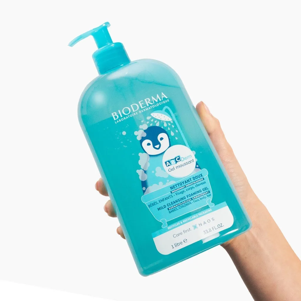 Hand holding Bioderma ABCDerm Gel Moussant bottle