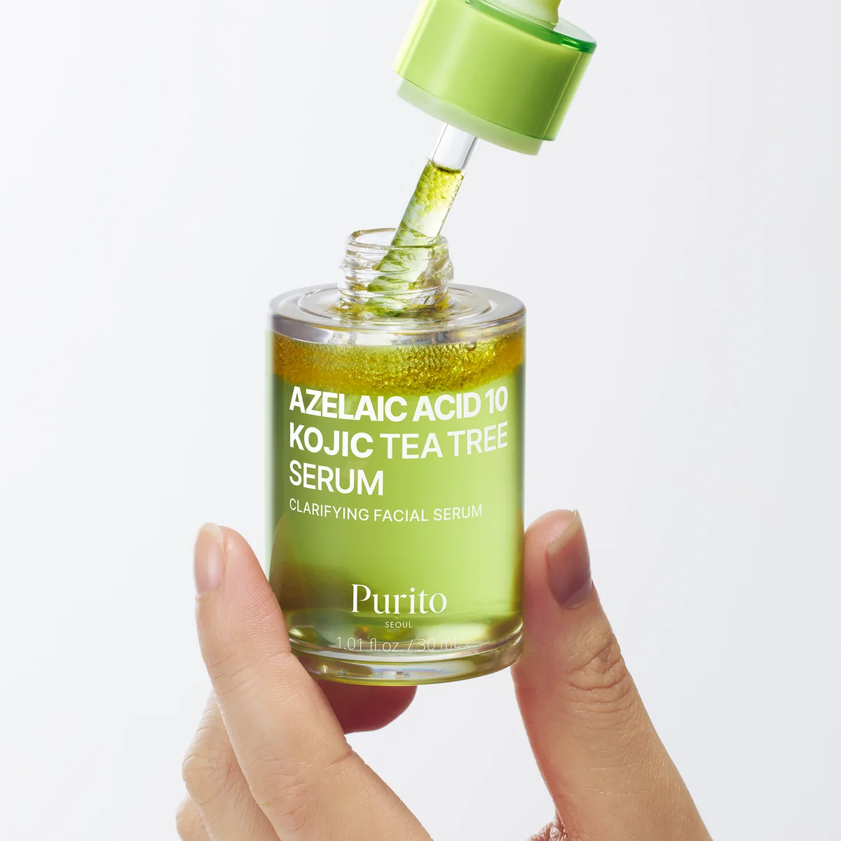 Purito Azelaic Acid 10 Kojic Serum 30ml bottle in hand