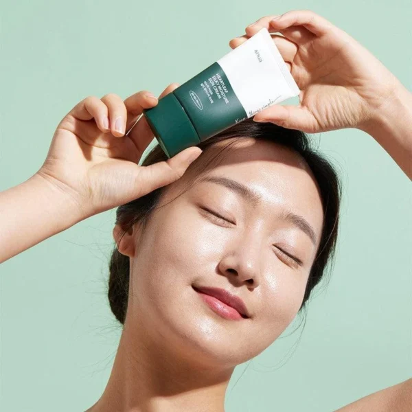 Anua Heartleaf Silky Sun Cream applied by model outdoors