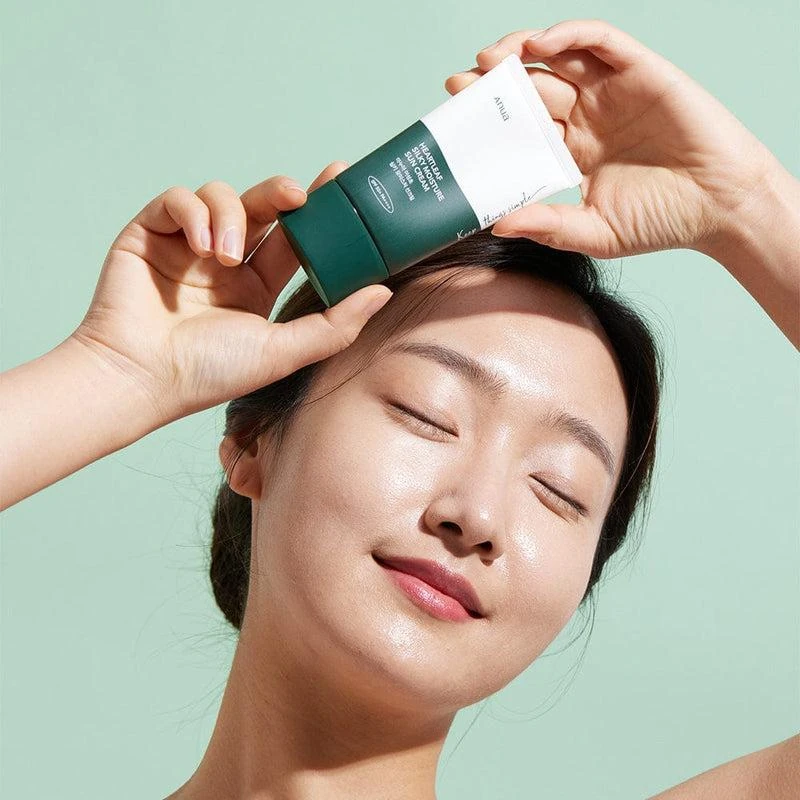 Anua Heartleaf Silky Sun Cream applied by model outdoors